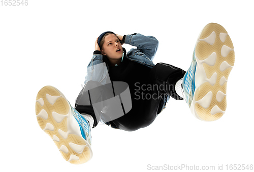 Image of Young stylish man in modern street style outfit isolated on white background, shot from the bottom