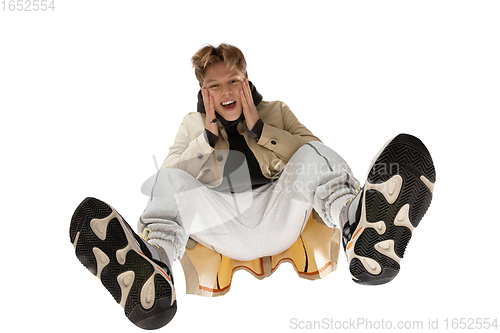 Image of Young stylish man in modern street style outfit isolated on white background, shot from the bottom