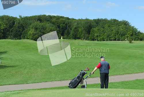 Image of Senior  holding a golf caddie