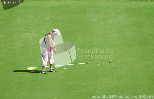 Image of old woman playing golf