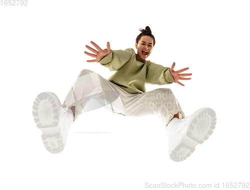 Image of Young stylish woman in modern street style outfit isolated on white background, shot from the bottom