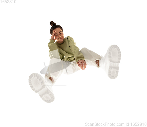 Image of Young stylish woman in modern street style outfit isolated on white background, shot from the bottom