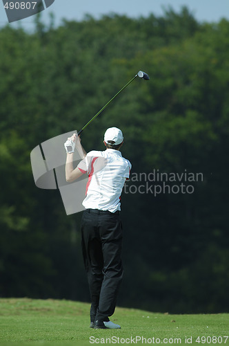 Image of man golfer doing a swing