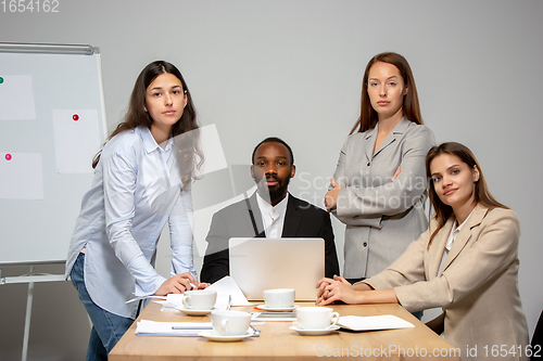 Image of Young people talking, working during videoconference with colleagues at office or living room