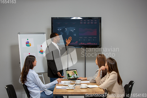 Image of Young people talking, working during videoconference with colleagues at office or living room