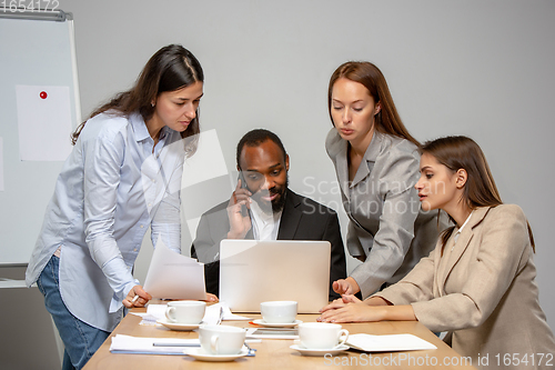 Image of Young people talking, working during videoconference with colleagues at office or living room