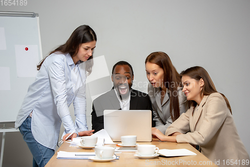 Image of Young people talking, working during videoconference with colleagues at office or living room