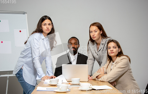 Image of Young people talking, working during videoconference with colleagues at office or living room