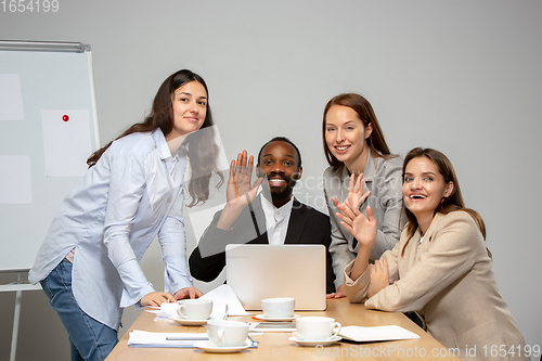 Image of Young people talking, working during videoconference with colleagues at office or living room