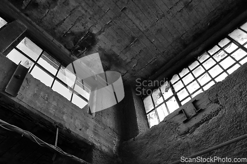 Image of broken windows concrete wall in derelict factory