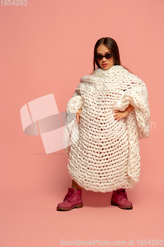 Image of Caucasian female inclusive model posing on pink studio background in stylish outfit