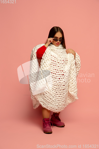 Image of Caucasian female inclusive model posing on pink studio background in stylish outfit