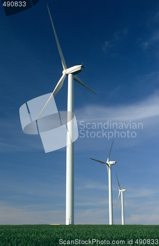 Image of Three windturbines on blue sky 