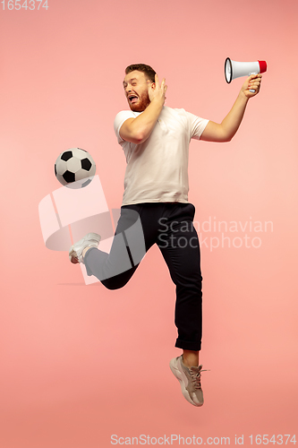 Image of Full length portrait of young successfull high jumping man gesturing isolated on pink studio background