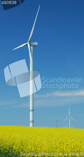 Image of farm of windturbines close to rape field 