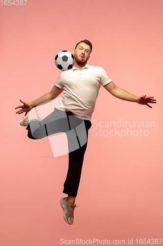 Image of Full length portrait of young successfull high jumping man gesturing isolated on pink studio background