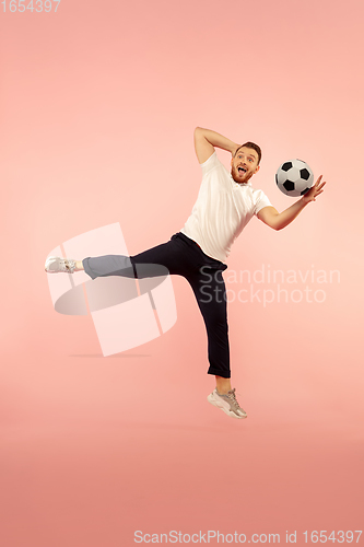 Image of Full length portrait of young successfull high jumping man gesturing isolated on pink studio background