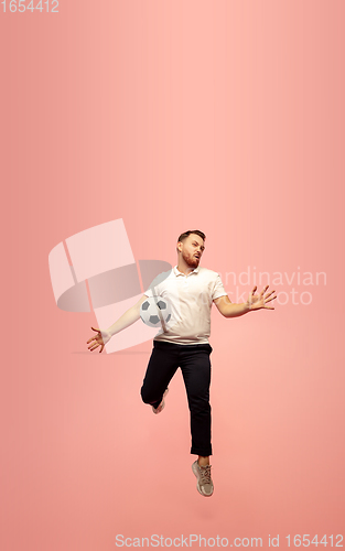 Image of Full length portrait of young successfull high jumping man gesturing isolated on pink studio background