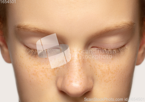 Image of Close up portrait of beautiful redhair caucasian girl isolated on studio background. Beauty, fashion, skincare, cosmetics concept. Details.