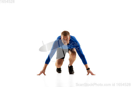 Image of Caucasian professional runner, jogger training isolated on white studio background in fire