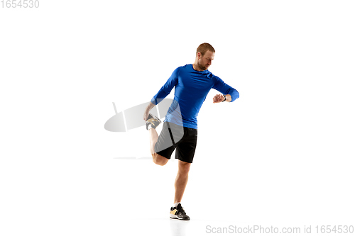 Image of Caucasian professional runner, jogger training isolated on white studio background in fire
