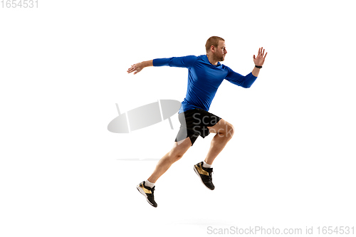 Image of Caucasian professional runner, jogger training isolated on white studio background in fire