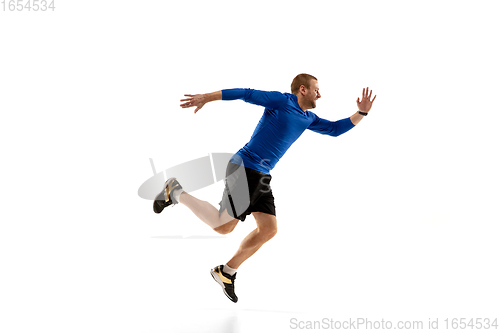 Image of Caucasian professional runner, jogger training isolated on white studio background in fire