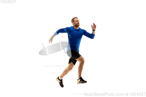Image of Caucasian professional runner, jogger training isolated on white studio background in fire