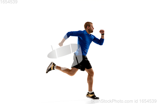 Image of Caucasian professional runner, jogger training isolated on white studio background in fire