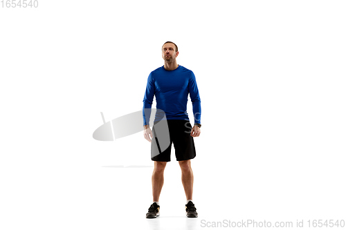 Image of Caucasian professional runner, jogger training isolated on white studio background in fire