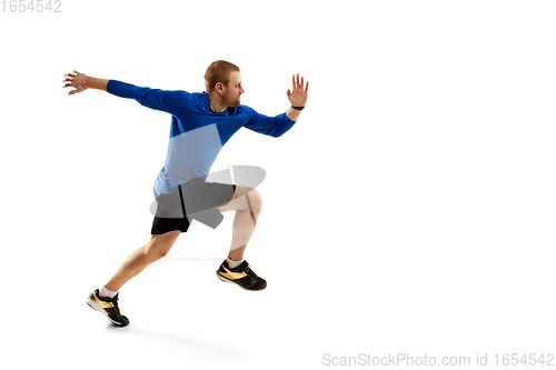 Image of Caucasian professional runner, jogger training isolated on white studio background in fire
