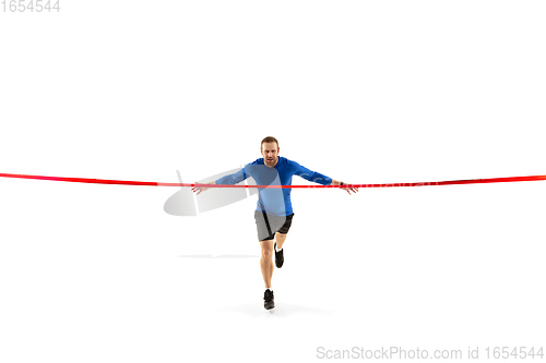 Image of Caucasian professional runner, jogger training isolated on white studio background in fire