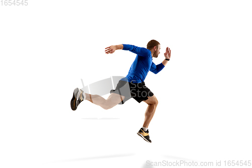 Image of Caucasian professional runner, jogger training isolated on white studio background in fire