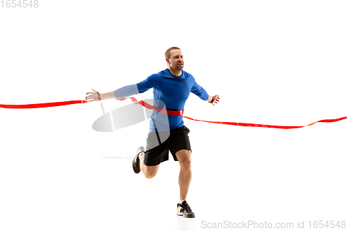 Image of Caucasian professional runner, jogger training isolated on white studio background in fire