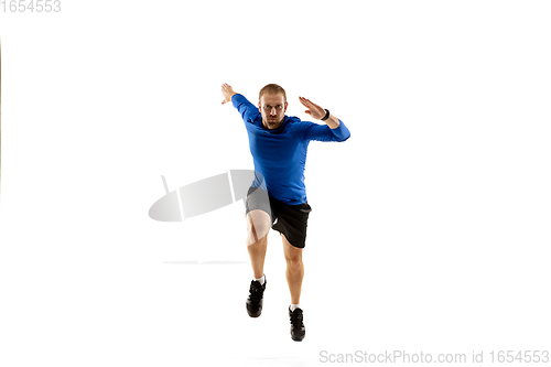 Image of Caucasian professional runner, jogger training isolated on white studio background in fire