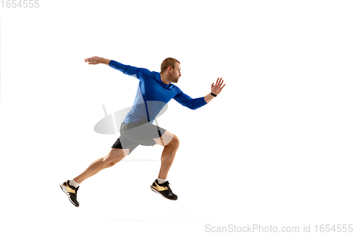 Image of Caucasian professional runner, jogger training isolated on white studio background in fire