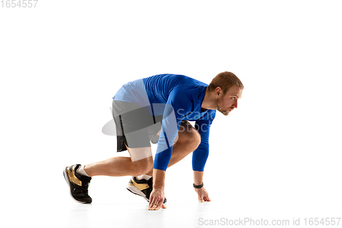 Image of Caucasian professional runner, jogger training isolated on white studio background in fire