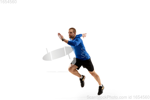 Image of Caucasian professional runner, jogger training isolated on white studio background in fire