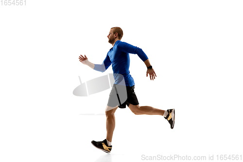 Image of Caucasian professional runner, jogger training isolated on white studio background in fire