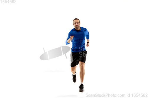 Image of Caucasian professional runner, jogger training isolated on white studio background in fire