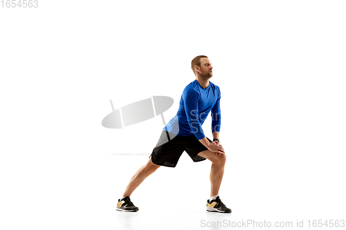 Image of Caucasian professional runner, jogger training isolated on white studio background in fire