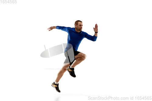 Image of Caucasian professional runner, jogger training isolated on white studio background in fire