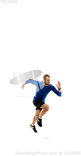 Image of Caucasian professional runner, jogger training isolated on white studio background in fire