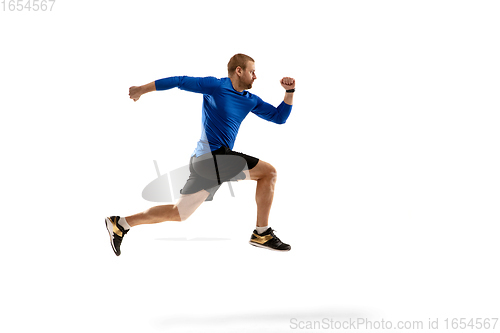 Image of Caucasian professional runner, jogger training isolated on white studio background in fire