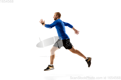 Image of Caucasian professional runner, jogger training isolated on white studio background in fire