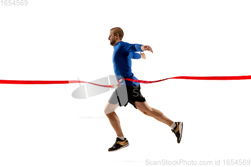 Image of Caucasian professional runner, jogger training isolated on white studio background in fire