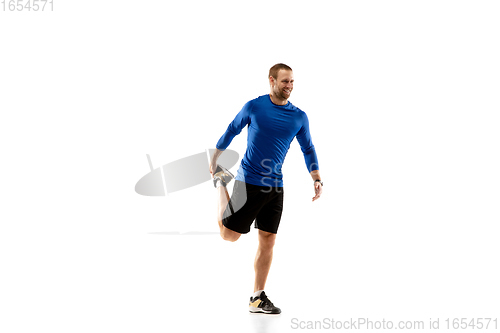 Image of Caucasian professional runner, jogger training isolated on white studio background in fire