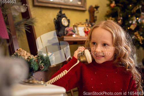 Image of Cheerful little girl looking for home decoration and holiday\'s gifts in household store