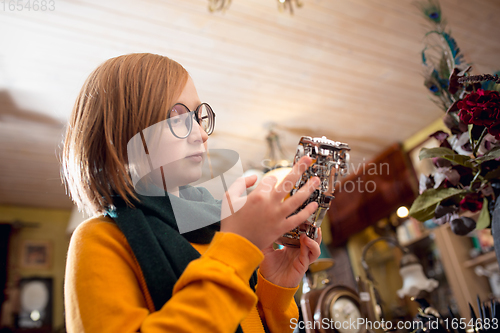 Image of Cheerful little boy looking for home decoration and holiday\'s gifts in household store