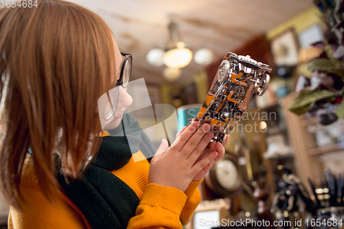 Image of Cheerful little boy looking for home decoration and holiday\'s gifts in household store